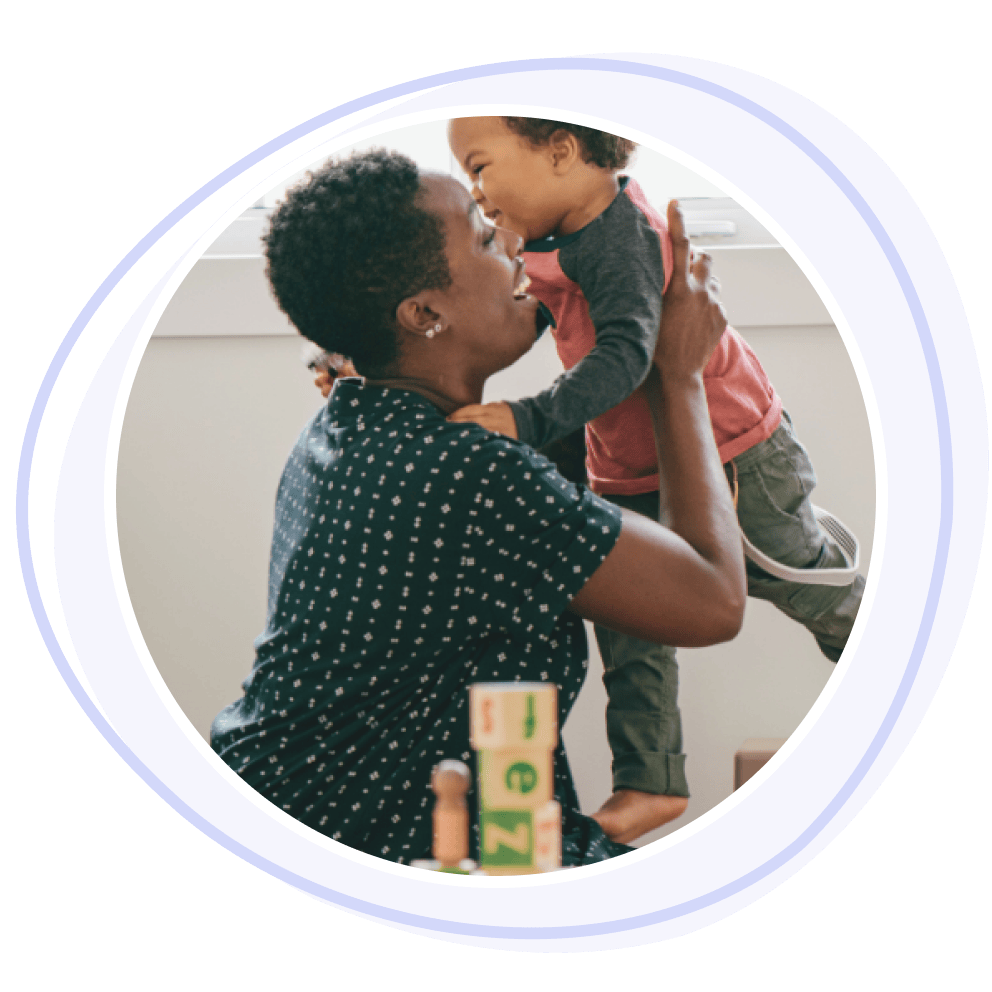 Childminder lifting up a child