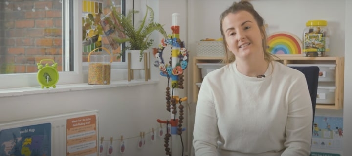 Childminder doing hand paints with children